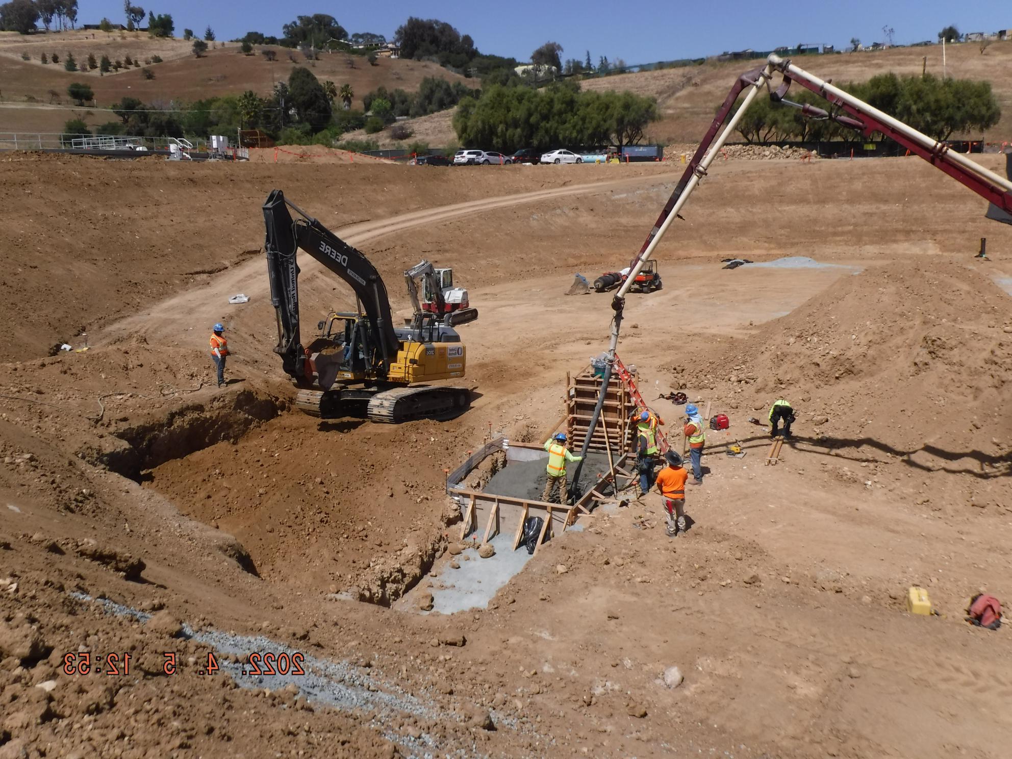 Heavy equipment prepares base of new water tank